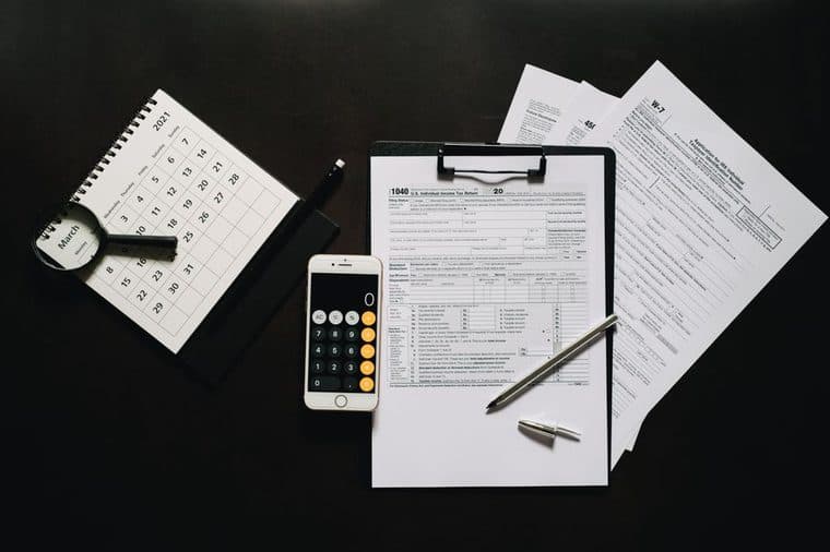 Tax paperwork and a calculator under review on a desk