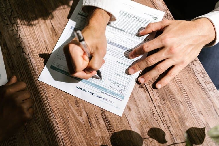 A person filling out a loan application form